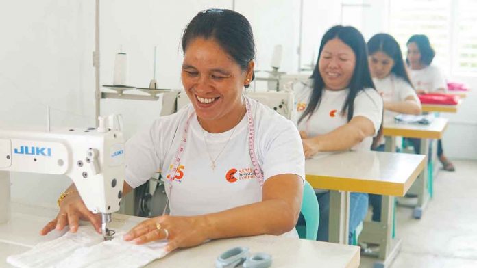 Members of the Women’s Association of Barangay Tinogboc in Semirara Island at the sewing center, tailoring their way to better lives through Semirara Mining and Power Corporation’s dressmaking livelihood program.