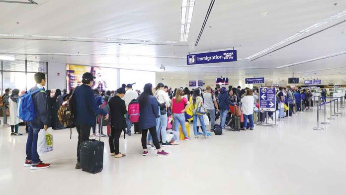 Travelers queue at the Ninoy Aquino International Airport immigration counters. TOURISM.GOV.PH PHOTO