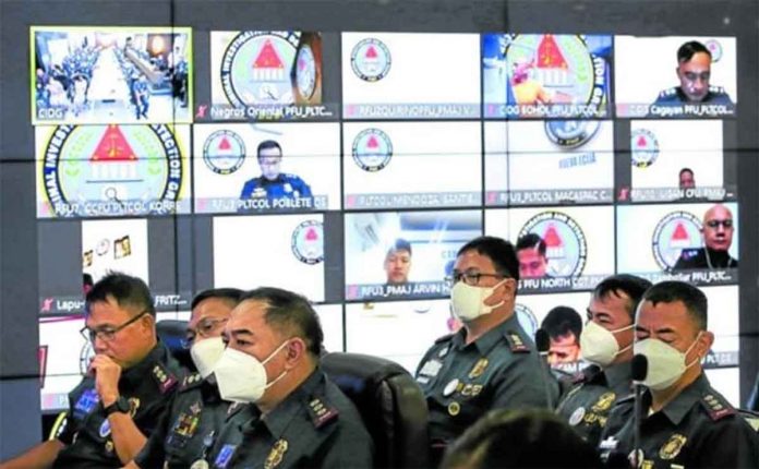 COMMAND CHANGE. Criminal Investigation and Detection Group (CIDG) officials, including those attending online, listen to the speech of PNP chief Gen. Rodolfo Azurin Jr. during the assumption of office ceremony for Brig. Gen. Romeo Caramat Jr. as head of the CIDG in Camp Crame on Monday. Azurin discussed the courtesy resignations within the PNP in his message. LYN RILLON PHILIPPINE DAILY INQUIRER