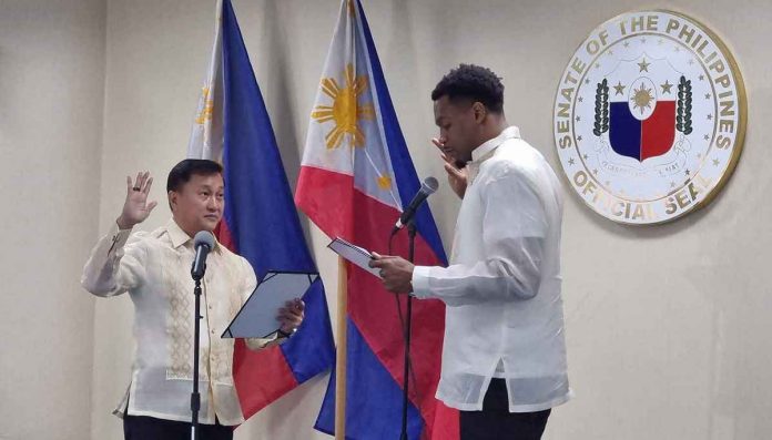 Barangay Ginebra San Miguel Kings import Justin Brownlee takes an oath of allegiance to the Philippines before Sen. Francis Tolentino. PHOTO COURTESY OF JOHN CARLO CAHINHINAN