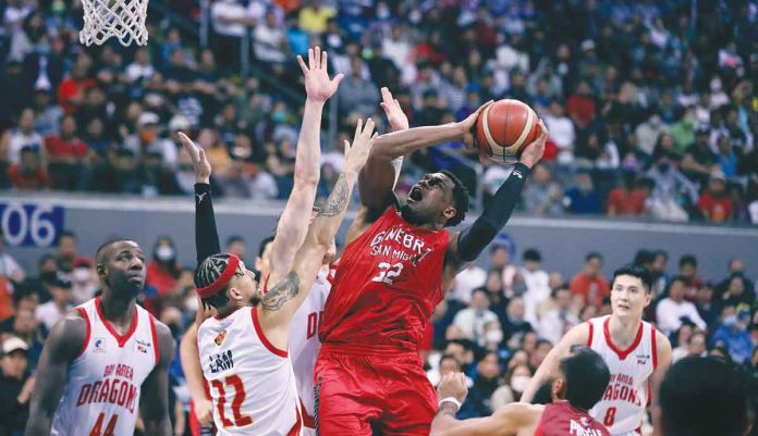 Barangay Ginebra San Miguel Kings’ Justin Brownlee is forced to a tough basket by Bay Area Dragons’ Kobey Lam. PBA PHOTO