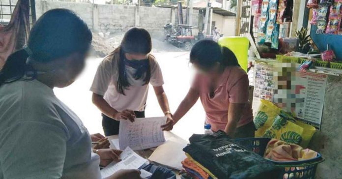 Personnel of the Philippine Statistics Authority in Iloilo deliver digital copies of the Philippine Identification System to their owners in this undated photo. PSA ILOILO PHOTO