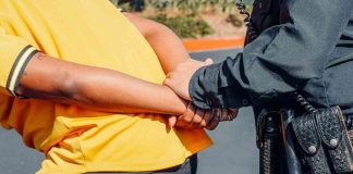 Photo by Kindel Media: https://www.pexels.com/photo/police-officer-arresting-a-man-in-yellow-shirt-7715070/