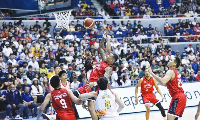 Barangay Ginebra San Miguel Kings’ Jamie Malonzo is forced to a tough basket by Rain or Shine Elasto Painters' defense. PBA PHOTO