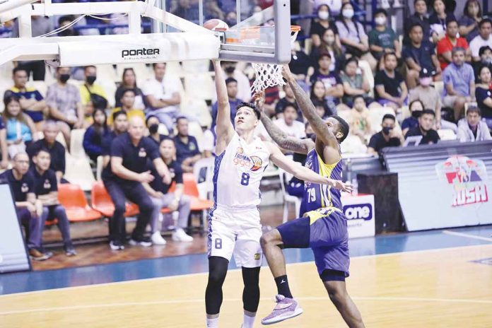 TNT Tropang Giga's Calvin Oftana goes for a layup as Magnolia Chicken Timplados Hotshots' Erik McCree attempts a block. PBA PHOTO