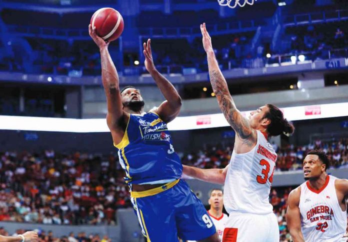 Magnolia Chicken Timplados Hotshots’ Antonio Hester goes for a fall away basket against the defense of Barangay Ginebra San Miguel Kings’ Christian Standhardinger. PBA PHOTO