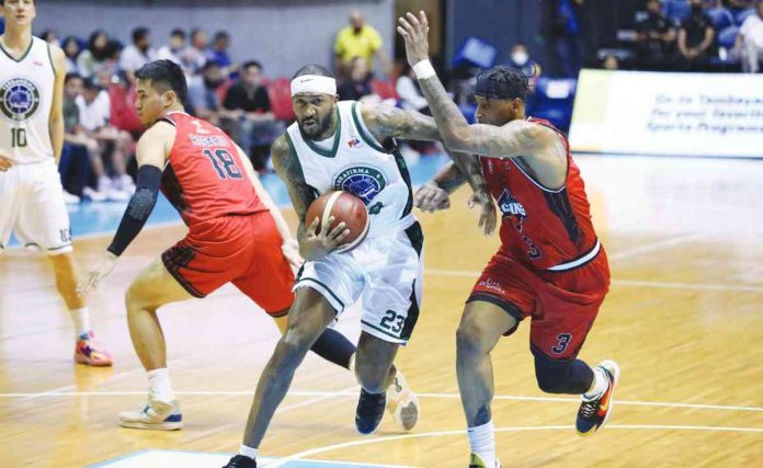 Terrafirma Dyip’s Jordan Williams (left) wards off the defense of Blackwater Bossing’s Troy Williams (right) for an inside attack. PBA PHOTO