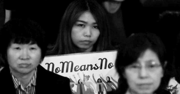 A woman holds a sign saying no means no. AFP