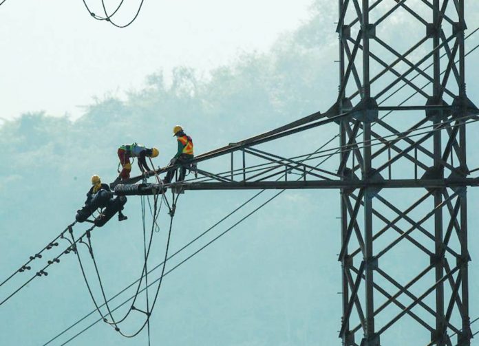 Linemen work on cleaning the powerlines that straddle the Tagaytay ridge overlooking the Taal lake in Batangas. JONATHAN CELLONA, ABS-CBN NEWS/FILE PHOTO