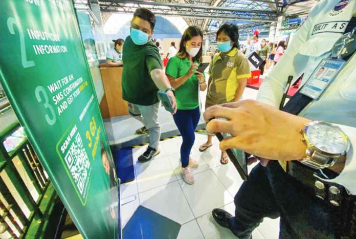 A sales representative of a telecommunications company assists clients in registering their prepaid subscriber identity module (SIM) card. JONATHAN CELLONA/ABS-CBN NEWS PHOTO