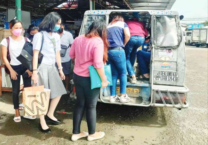 Drivers Carlos Deasis and Jayson Tandog welcome the extension of the validity of the franchises of traditional jeepneys from June 30 to Dec. 31, 2023 but stress they’ll be happier if the phaseout of traditional jeepneys won’t push through. Right photo shows passengers boarding a traditional jeepney at the Mohon terminal in Arevalo, Iloilo City. AJ PALCULLO/PN