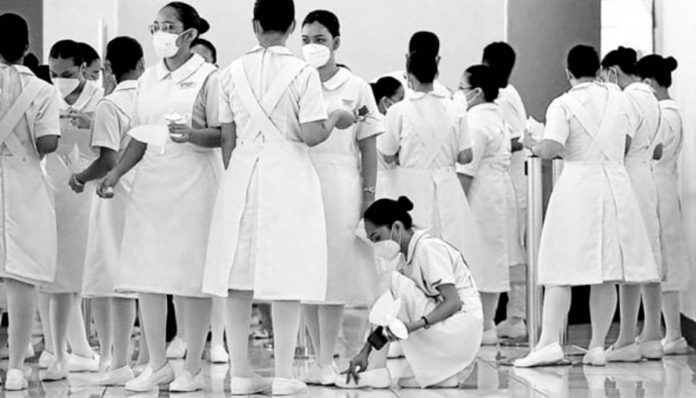 One in 20 nurses in the United States is Filipino, following decades of migration of nurses from the Philippines, which is now lacking 106,000 nurses, to American soil. Here, future nurses from Centro Escolar University are at the World Trade Center in Pasay City for their capping and pinning rites, on Sept. 30, 2022. File photo by RICHARD A. REYES / Philippine Daily Inquirer