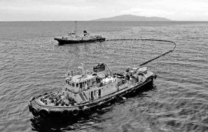 Together with an oil spill boom and skimmer, the Philippine Coast Guard goes around the suspected area of the sunken oil tanker MT Princess Empress at the northeast of Balingawan Port, Lucta Port, and Buloc Bay in Oriental Mindoro on March 14, 2023.