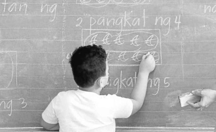 A teacher and her students learn together at the Pedro Cruz Elementary School in San Juan City as it reopened its face-to-face classes. The school passed the DepED Schools Safety Assessment Tool which shows its readiness for the limited face-to-face learning modality. File photo by GRIG C. MONTEGRANDE / Philippine Daily Inquirer