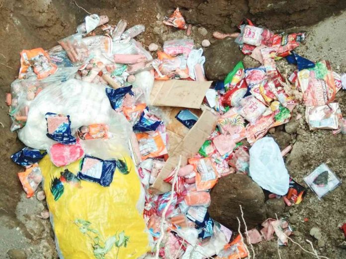 Authorities confiscated "unauthorized" frozen pork and other pork byproducts from public markets in Dumaguete City and Valencia town in Negros Oriental on Tuesday, March 14. Photo shows the Municipal Agriculture Office of Valencia chemical treating the items. MAO VALENCIA NEGOR FACEBOOK