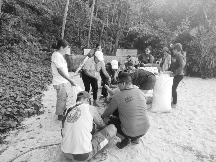 Personnel of the Philippine Coast Guard - Aklan, Philippine National Police, Municipal Disaster Risk Reduction and Management Office, and local government unit of Malay make improvised oil spill booms using bamboo and rice hay near the beachfront of Puka Beach, Barangay Yapak, Boracay Island, Malay, Aklan in preparation for a possible oil spill. PCG – AKLAN VIA PCG-WV PHOTO