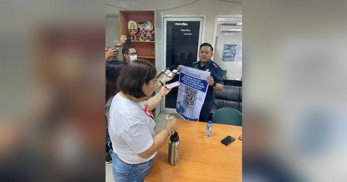 Police Colonel Noel Aliño, acting director of Bacolod City Police Office, shows the QR (quick response) code for the “Isugid kay Mayor” online complaints desk to reporters during his visit to the Government Center on Wednesday, April 19. BACOLOD CITY PIO PHOTO