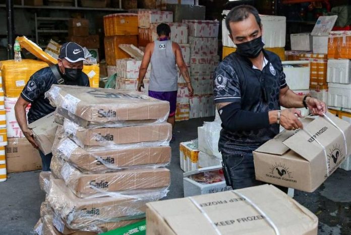 Operatives of the National Bureau of Investigation, Bureau of Customs, Bureau of Permits, and the Veterinary Inspection Board conduct a raid inside a compound in Juan Luna Street, Tondo Manila containing banned meat products and medical supplies in this file photo. ABS-CBN NEWS PHOTO