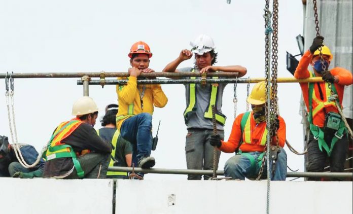 Photo shows construction workers on top of an unfinished building in Makati City. The Department of Finance said the Philippines is committed to ramp up the "underinvestment" in infrastructure as part of its growth strategy. GEORGE CALVELO, ABS-CBN NEWS/FILE PHOTO