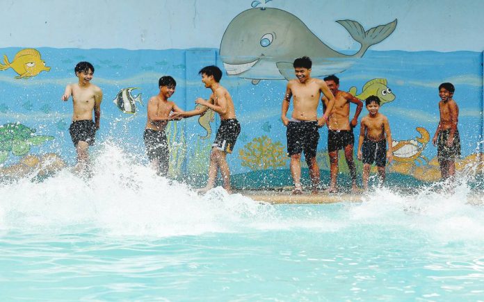 COOLING OFF. These boys try to beat the heat at a pool at Bernardo Park in Cubao, Quezon City. The state weather bureau on March 29 recorded a heat index as high as 42°C at 2 p.m. in Pangasinan and 38°C in Metro Manila. PNA PHOTO