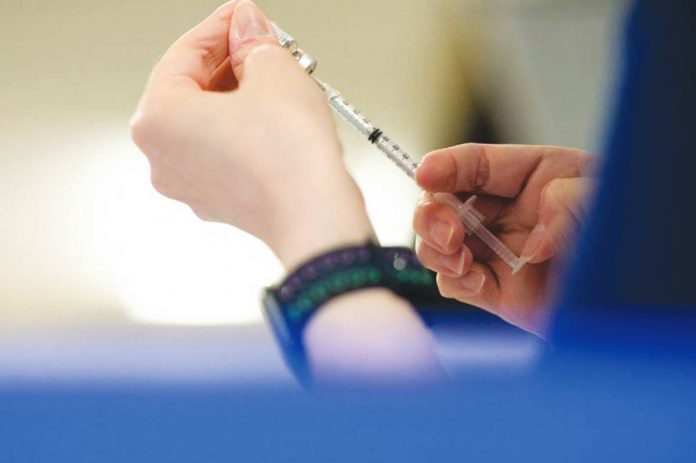 A nurse fills up a syringe with the coronavirus disease vaccines in this file photo. REUTERS