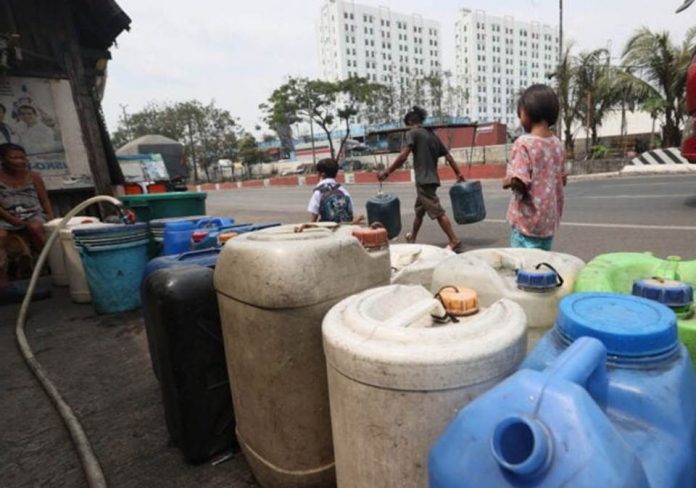 Residents of Barangay 101 in Tondo, Manila, line up their plastic containers to collect water after Maynilad Water Services Inc. announced daily water service interruptions in Metro Manila starting March 28 and 29, 2023. The firm also urged the public to conserve water as the El Nino phenomenon looms. FILE PHOTO BY MARIANNE BERMUDEZ / PHILIPPINE DAILY INQUIRER