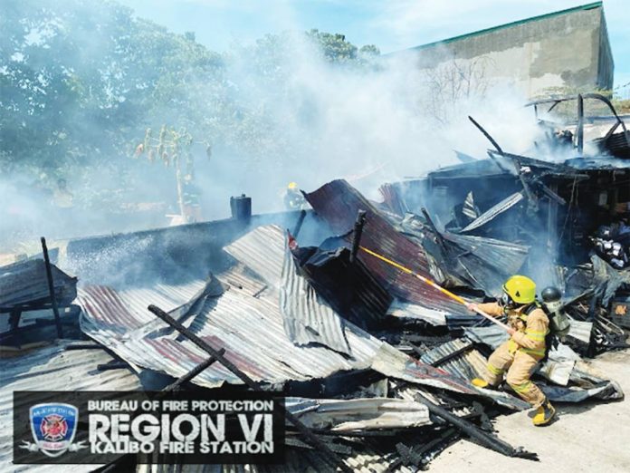 Smoke billows from a pile of corrugated galvanized iron sheets – ruins of a house and fruit stand that fire struck in Numancia, Aklan on April 1.