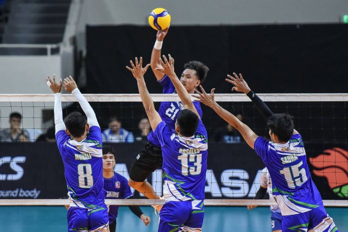 D’Navigators-Iloilo’s Jade Disquitado attempts a drop shot against three Imus-Ivy Tuason Photography AJAA Spikers defenders. SPIKERS’ TURF PHOTO