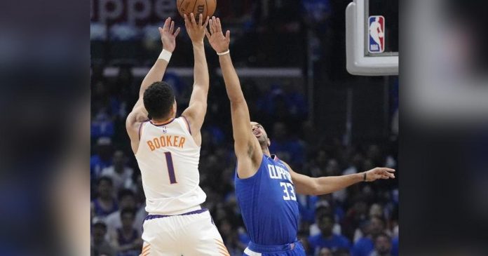 Phoenix Suns’ Devin Booker goes for the basket as LA Clippers’ Nicolas Batum tries to block the shot. AP