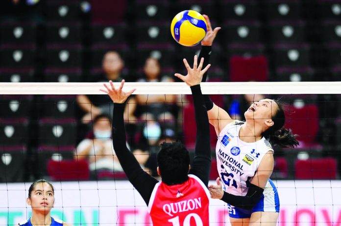 Negrense Myrtle Escanlar of the National University Lady Bulldogs scores against the defense of University of the East Lady Warriors’ Jhumelle Quizon. UAAP PHOTO