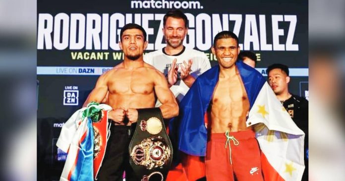 Filipino boxer Marlon Tapales (right) emerges victorious with the WBA and IBF super bantamweight belts after a split decision win over Murodjon Akhmadaliev. SANMAN PROMOTIONS PHOTO