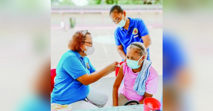 A senior citizen gets her dose of anti-COVID-19 vaccine at the municipal health center of Dueñas, Iloilo. DUEÑAS MUNICIPAL HEALTH OFFICE FB PHOTO