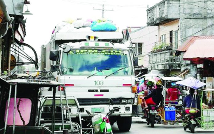 A garbage truck is collecting trash in Bacolod City in this undated photo. The city government will soon launch a mobile application that will allow households and business establishments to book a garbage pick-up. PNA BACOLOD FILE PHOTO