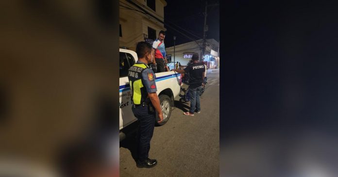 Last night's operation of the Iloilo City Public Safety and Transportation Management Office netted several traffic violators. Photo shows a traffic personnel apprehending a motorcycle driver with two kids as backriders, with no helmet and driver's license. PSTMO PHOTO