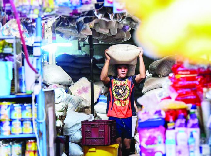 Workers stack sacks of locally produced sugar at the Marikina Public Market in Marikina City on Tuesday, May 16. MARIA TAN/ABS-CBN NEWS PHOTO