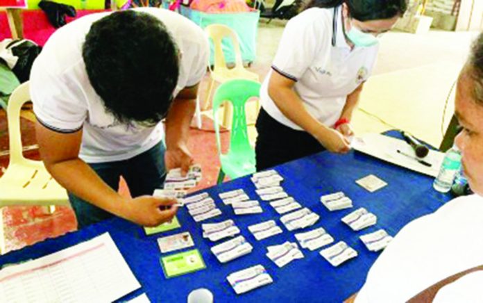 Assigned personnel distribute Bacolod City Comprehensive Health Program (BacCHP) family health membership cards to qualified beneficiaries. BacCHP aims to make access to medical services easier for indigent families. BACOLOD CITY PIO PHOTO