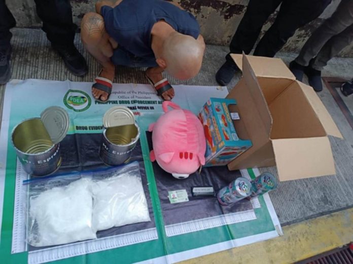 This photo from the Philippine Drug Enforcement Agency shows a consignee-suspect and the confiscated crystal meth (locally known as “shabu”) worth P12,240,000 that was imported from San Jose City in California, United States. Authorities intercepted the illegal drug at the Port of Clark on May 9, 2023 then, in a controlled delivery operation, recovered the contraband from the suspect in Barangay Highway Hills, Mandaluyong City on May 11.