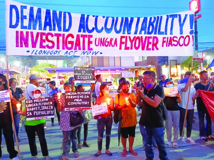 Protesters light candles at the defective flyover in Barangay Ungka II, Pavia, Iloilo. They demand for an investigation. AJ PALCULLO/PN