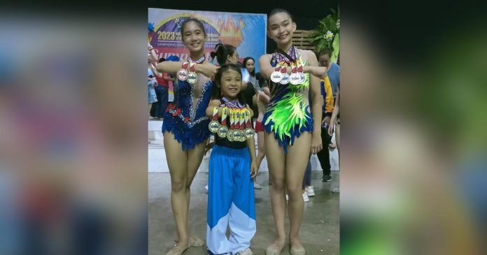 Bacolod Tay Tung High School gymnasts Jilian Krishna Dela Cruz, Reaiah Patricia Tan and Matthea Given Efenio display their 2023 WVRAA Meet medals. PHOTO COURTESY OF JOSE MONTALBO