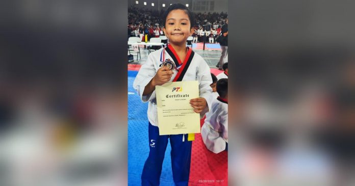 Iloilo MVP Taekwondo Gym’s Rhyden Uri Figueroa captures a gold medal in poomsae. PHOTO COURTESY OF DENMARK PINGGOL