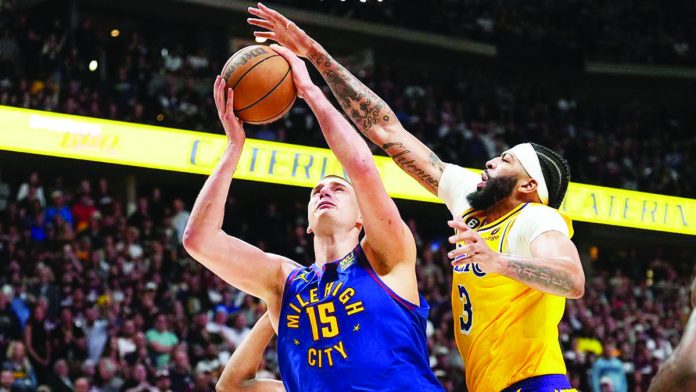 Denver Nuggets’ Nikola Jokic (left) goes for a shot as Los Angeles Lakers’ Anthony Davis tries to block him. AP