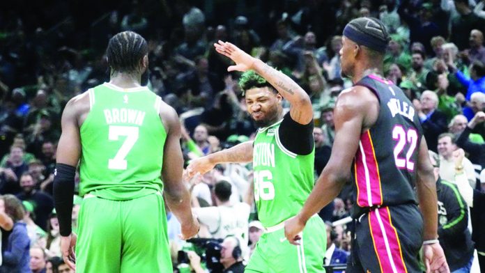 Marcus Smart and Jaylen Brown of the Boston Celtics rejoice as their team extends the Eastern Conference finals to Game 5. AP