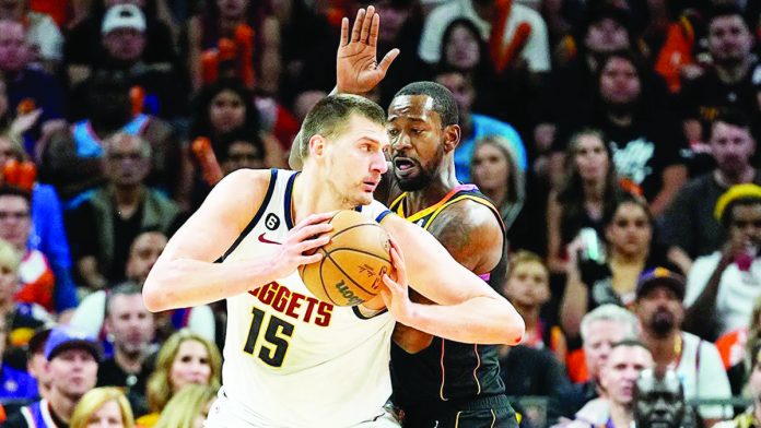 Nikola Jokic of the Denver Nuggets takes control of the ball. The Nuggets advances to the Western Conference finals of the NBA for the first time since 2020. AP