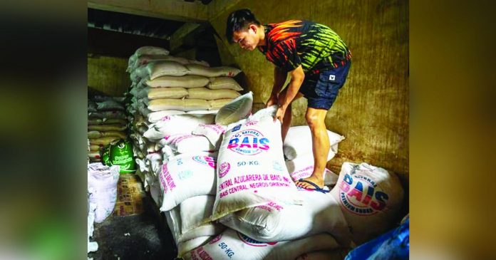 Workers stack sacks of locally produced sugar at a sugar retailer at the Marikina Public Market in Marikina City. President Ferdinand Marcos Jr. recently approved the additional importation of up to 150,000 metric tons of sugar in an effort to stabilize the commodity’s price amid continued inflation. MARIA TAN/ABS-CBN NEWS PHOTO