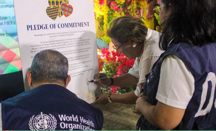 (left) Dr. Rui Paulo de Jesus, Country Representative of the World Health Organization, and (center) Gov. Rhodora J. Cadiao sign a pledge of commitment to the Healthy Hearts Program, which aims to promote cardiovascular health and reduce the burden of non-communicable diseases. ANTIQUE PROVINCIAL HEALTH OFFICE FB PAGE