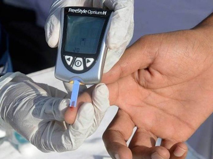 A nurse collects a blood sample using a glucometer at a free diabetic health check-up camp in India. GETTY IMAGES