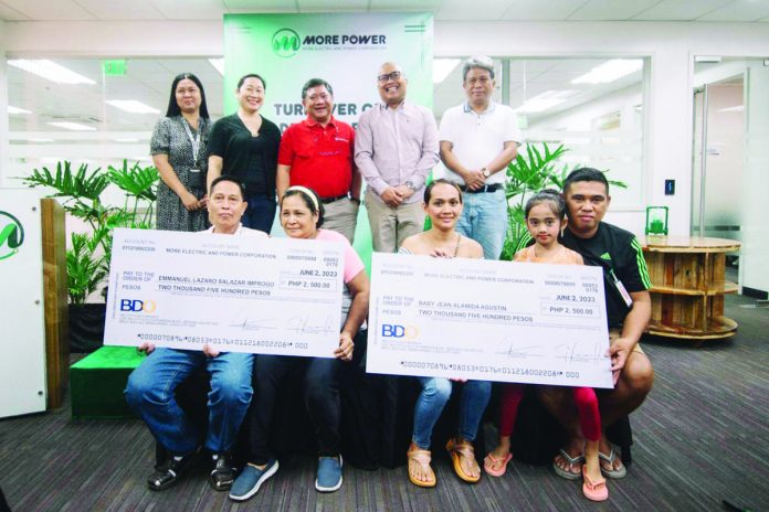 MORE Electric and Power Corporation (MORE Power) president and chief executive officer Roel Castro (standing, 3rd from left) leads the turnover of bill deposit refund to three consumers on Friday, June 2. Also in photo are (standing from left) MORE Power AVP for Customer Care Maricel Pe-Calunod, One Panay Consumer Alliance Inc. president Jane Javellana, Energy Regulatory Commission commissioner Alexis Lumbatan, and Grupo Konsumidor president Atty. Eldrid Antiquiera; and (sitting from left) consumers Emmanual Emprogo and wife and Baby Jean Agustin and family.