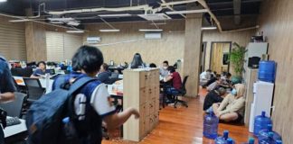 In this handout photo provided by the Philippine National Police Anti-Cybercrime Group, police walks inside one of the offices they raided in Las Piñas City, Metro Manila on Tuesday, June 27, 2023. PHILIPPINE NATIONAL POLICE ANTI-CYBERCRIME GROUP VIA AP