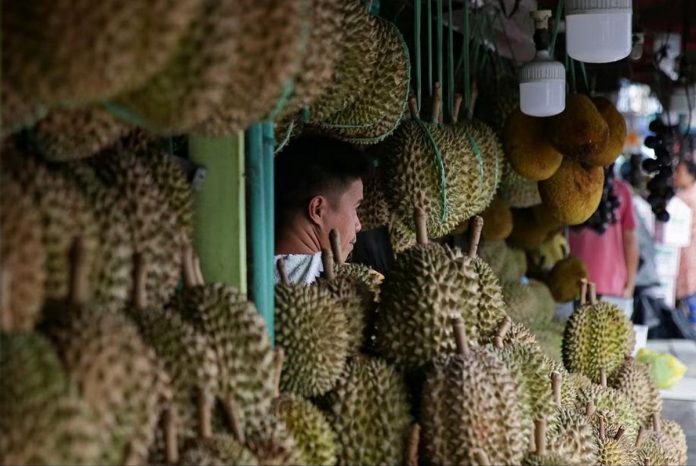 Durian and pomelo vendors man their stalls at a market in Davao City. GEORGE CALVELO/ABS-CBN NEWS PHOTO