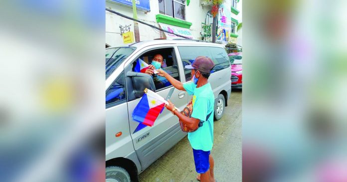 Ernesto Magsino said, beyond income, he sells Philippine Flags to show his loyalty to the country and to remind his fellow Ilonggos of the significance of Independence Day. AJ PALCULLO/PN